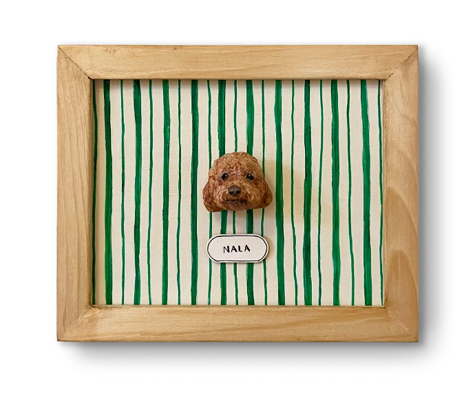 Handmade papier-mâché pet portrait in a green striped frame
